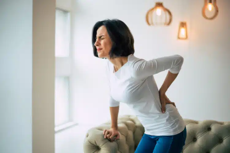 Woman With Back Pain -  high dose vitamin c shots in spring texas | Edge Weight Loss Fatigue