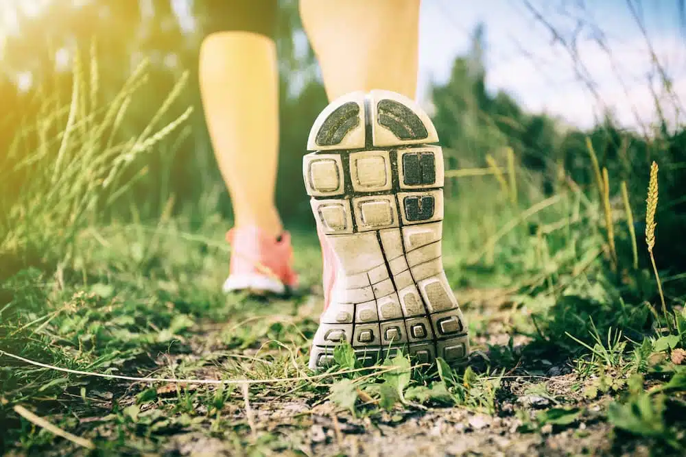 Woman getting in shape while walking in the forest