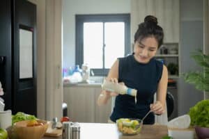 Woman making a health salad meal.