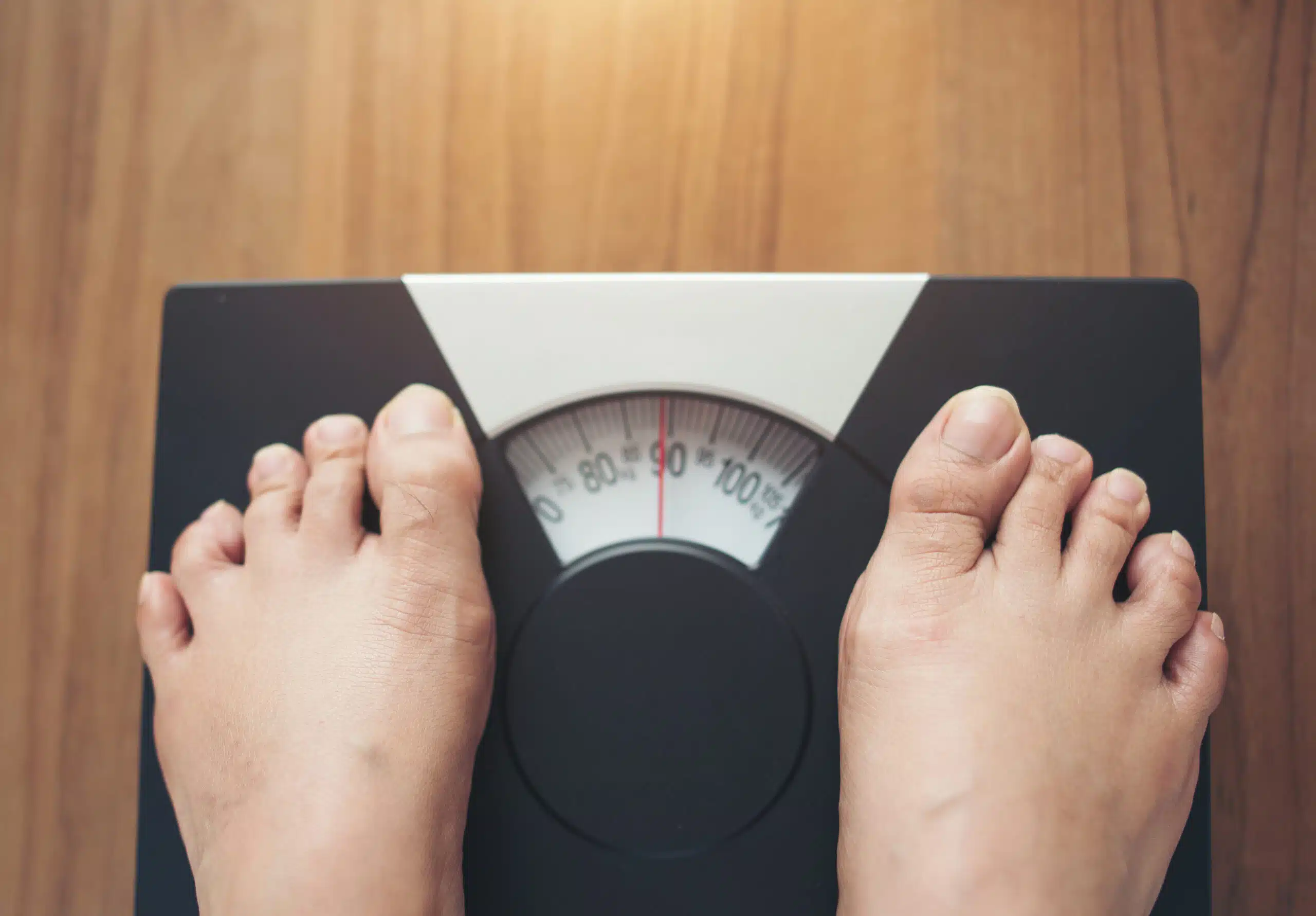 Woman feet standing on Weight Scale