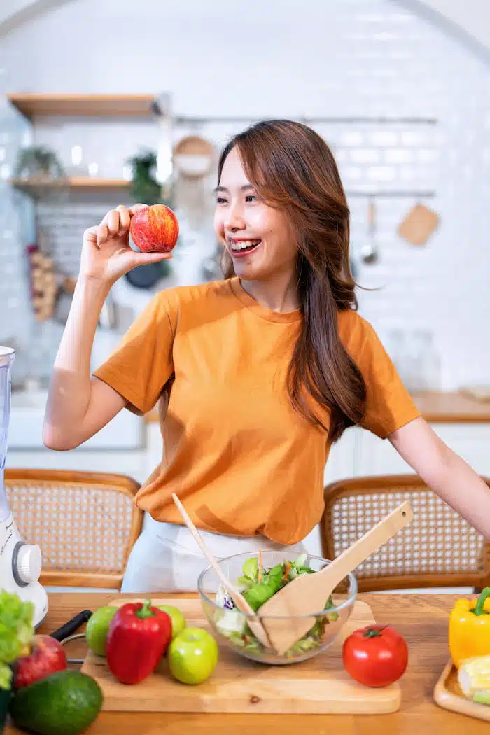 woman looking for the perfect diet plan on diabeetes management with fruit and vegetable on a table 