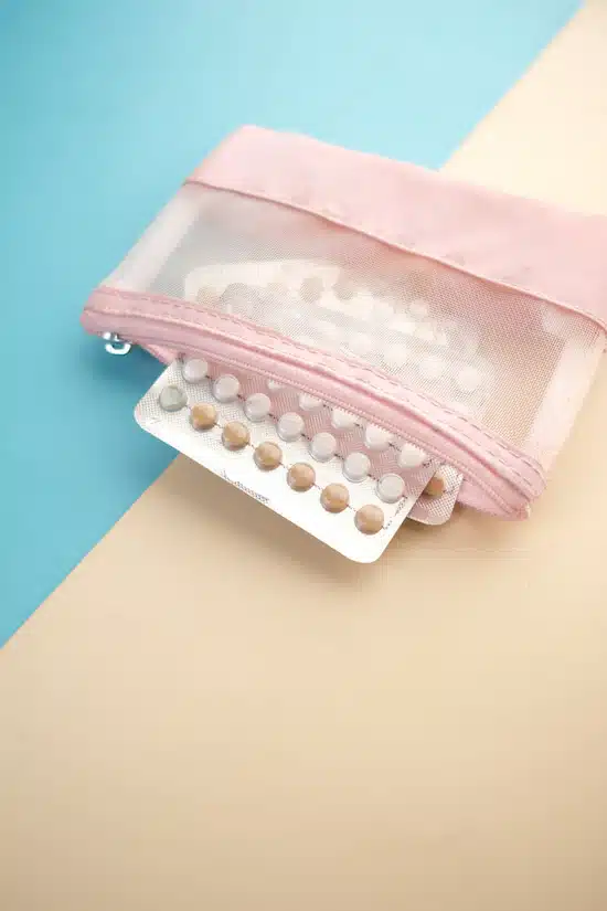 estrogen pills on a pink wallet for HRT