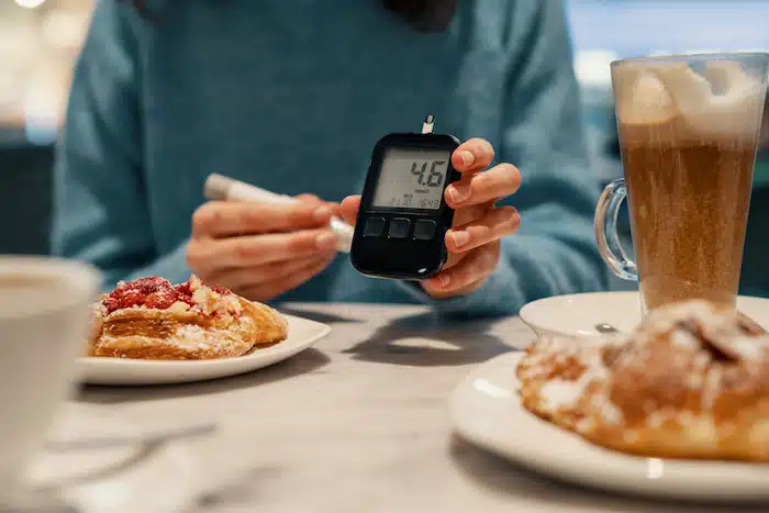 woman watching her blood sugar during dinner for diabetes management
