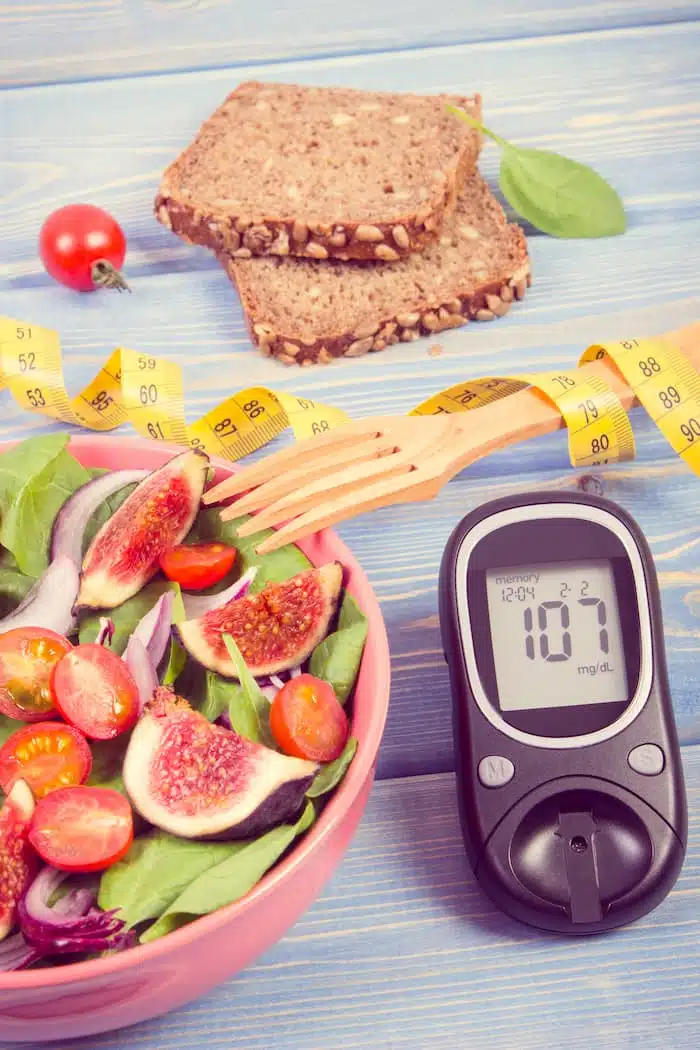 fruit and begetable on a table with glucometer for diabetes management