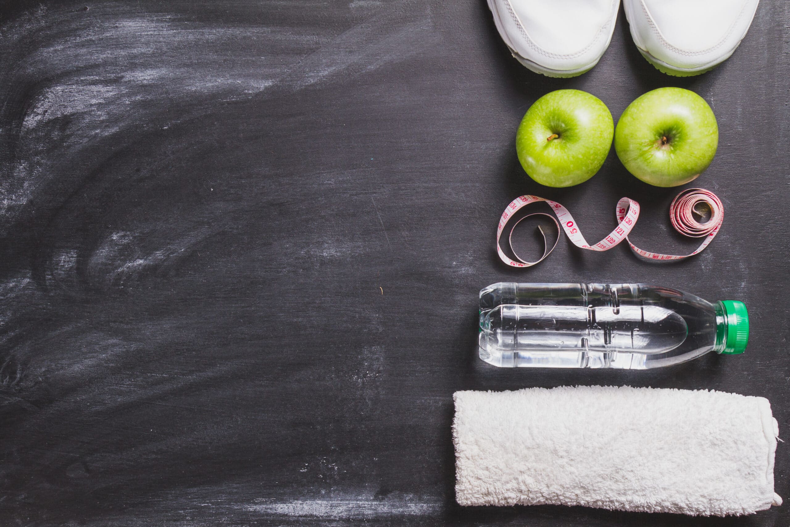 a background picture of fruit, water and tape measure for weight management