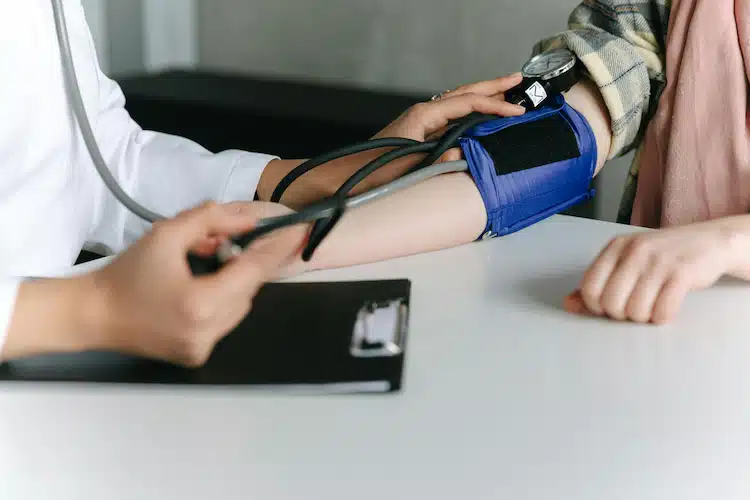 medical specialist checking patient's blood pressure