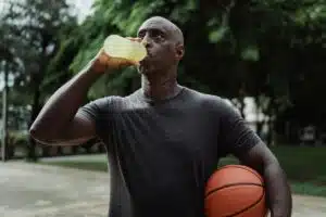 Man in Black Crew Neck T-shirt Drinking Yellow Liquid drink