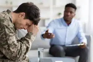 distressed man attending therapy