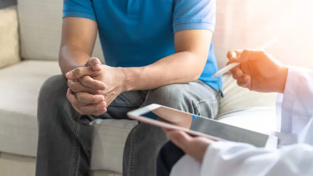 Man suffers from low testosterone having a consultation with a professional health consultant